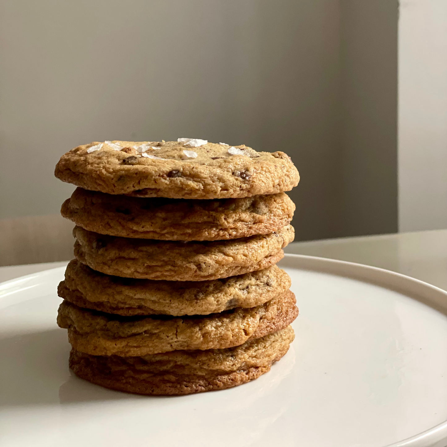 Stack of cookies on a white plate with a neutral background